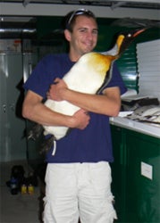 Butler holding penguin
