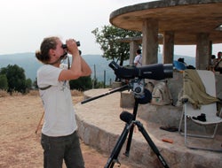 Scholer looking through binoculars