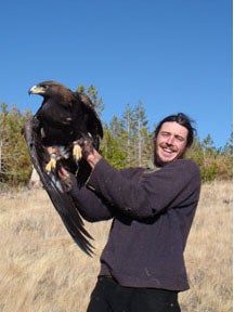 Rob Spaul holding a Golden Eagle in the field