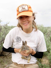 Jamie Utz holding a rabbit in the field