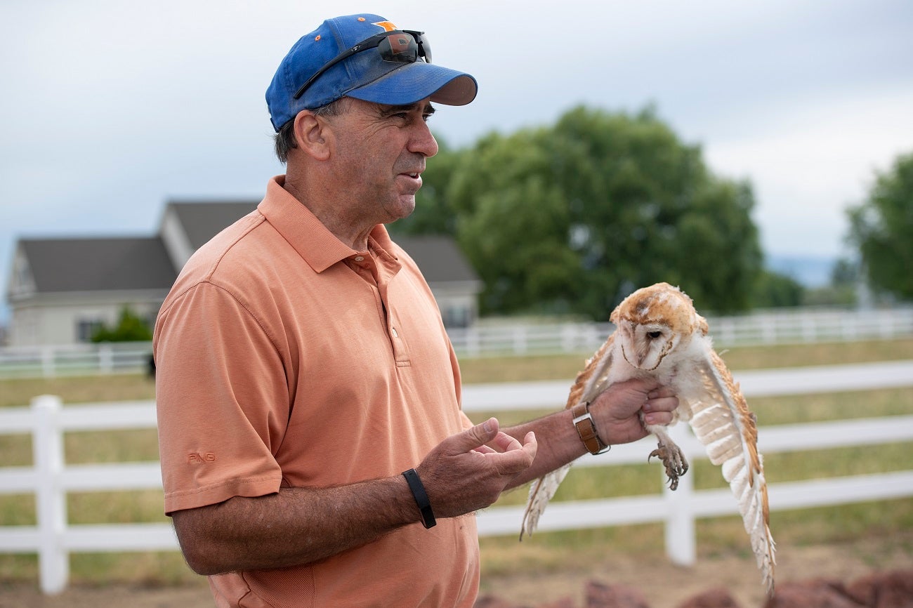 Jim Belthoff holding a barn owl.