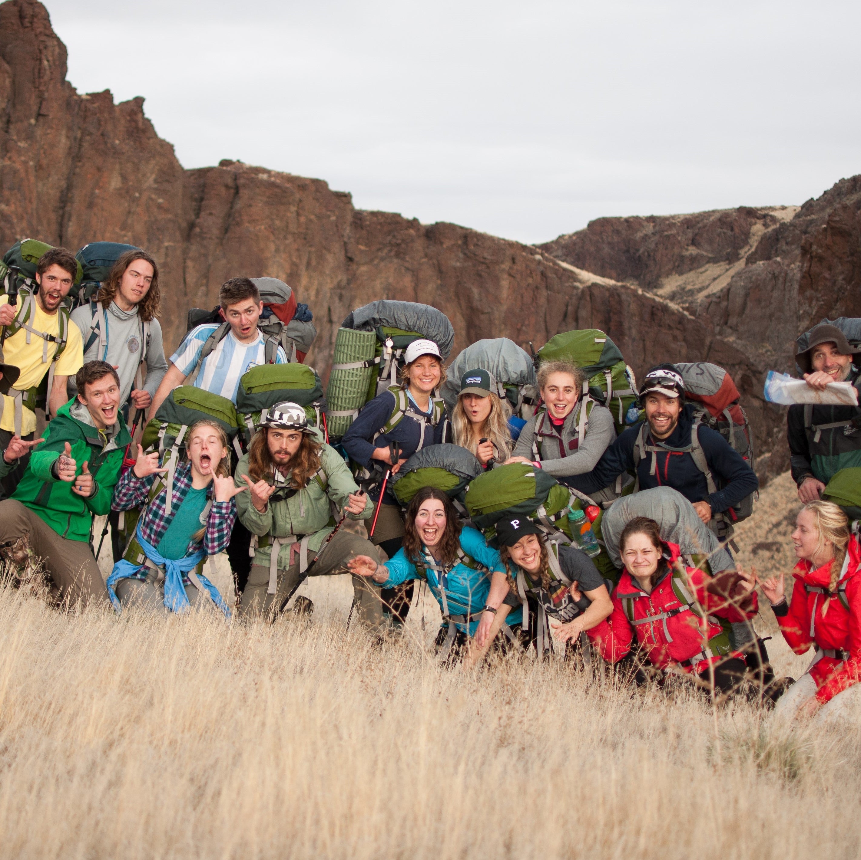 A group of people posing for a picture with hiking backpacks on