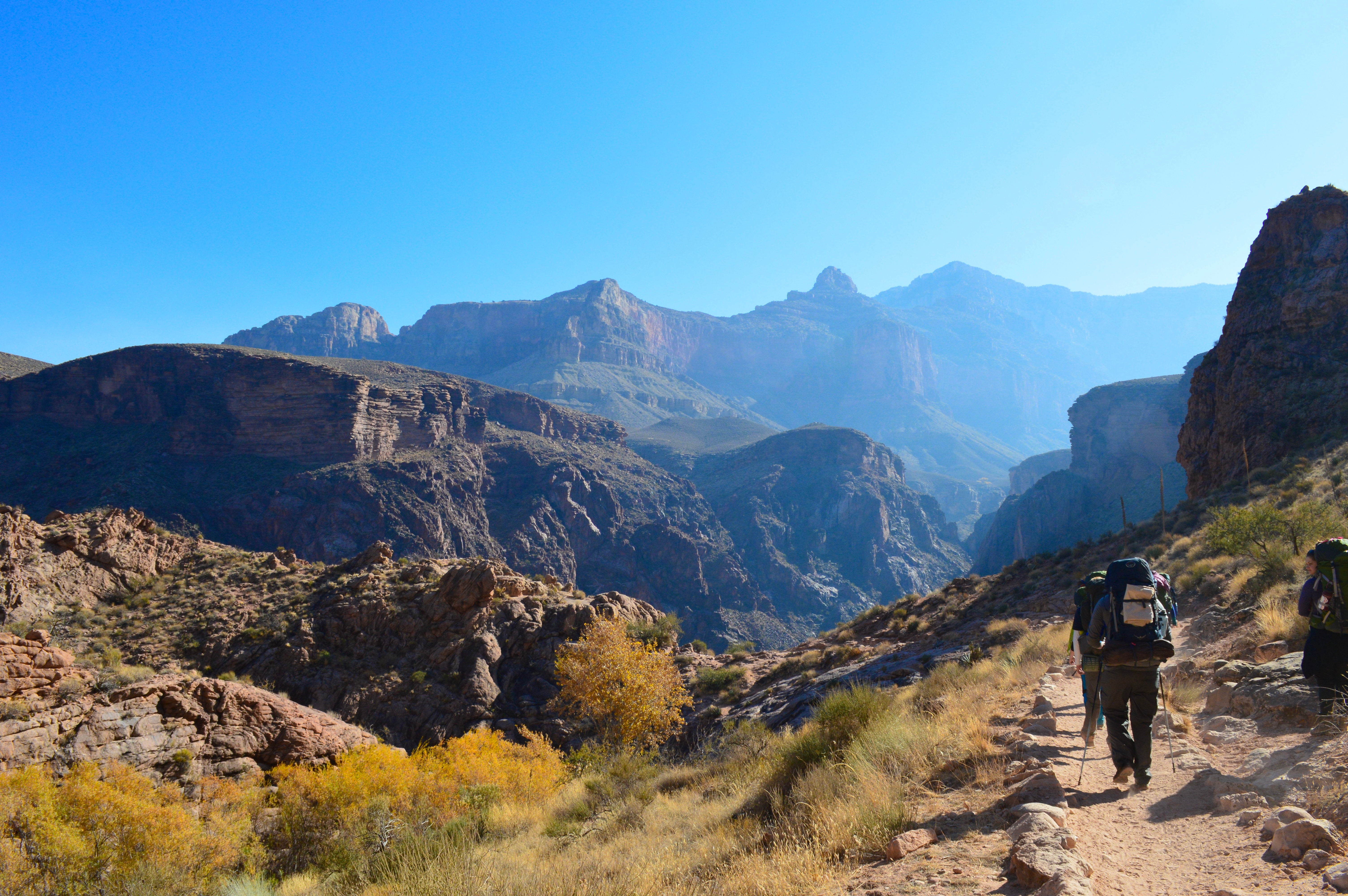 Group backpacks on a mountain trail