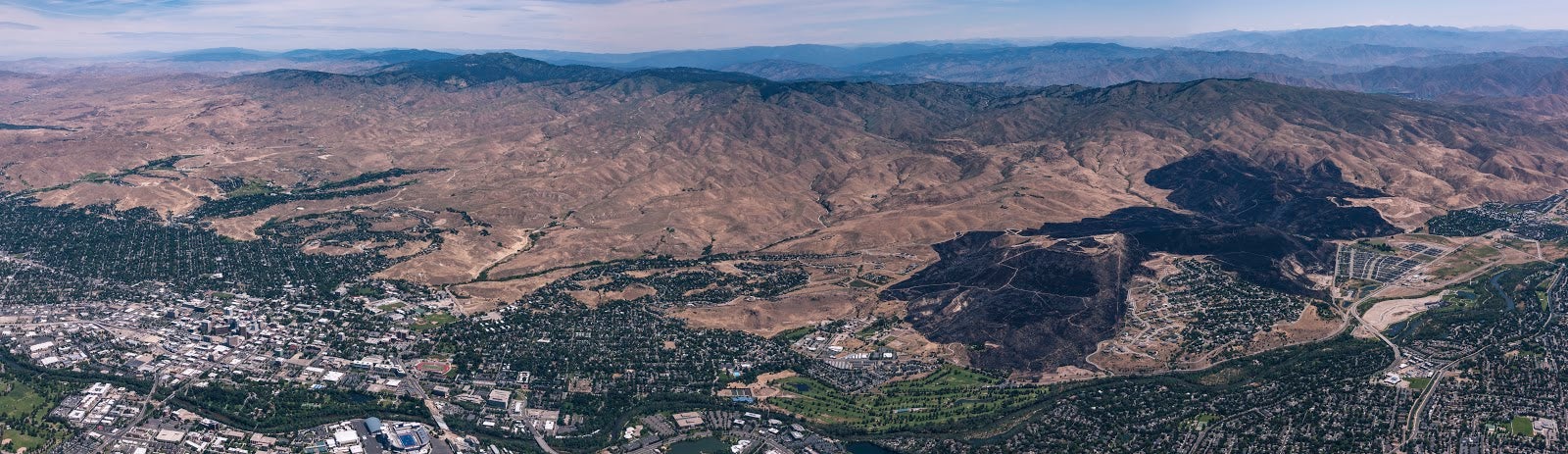Aerial view of Boise Foothills with large black patterns from fire