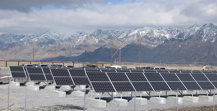 solar panels in a field at the base of a mountain