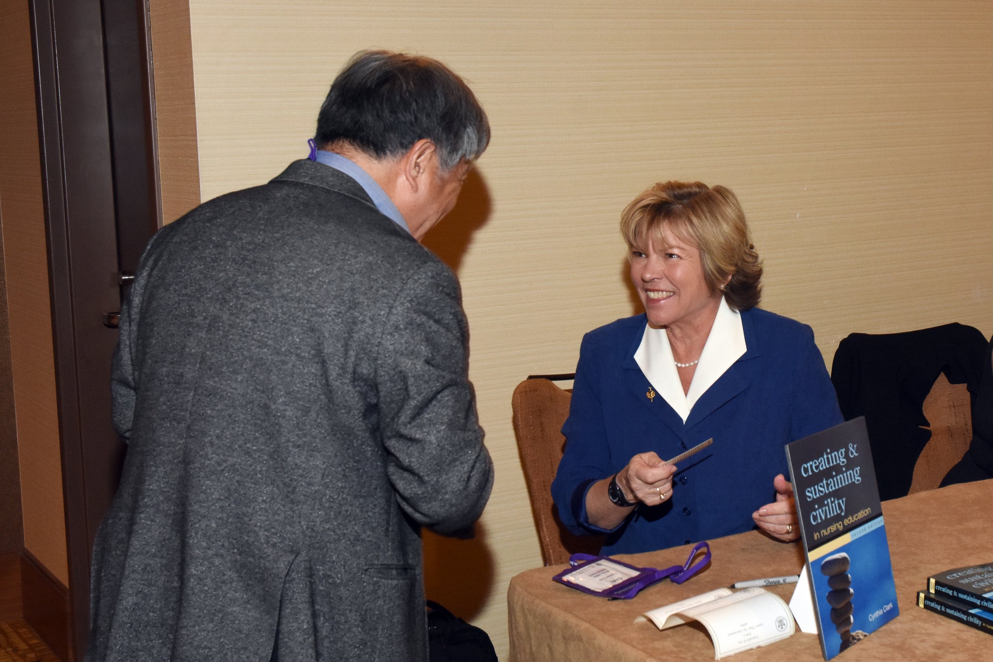 Dr. Clark speaking with someone at a conference
