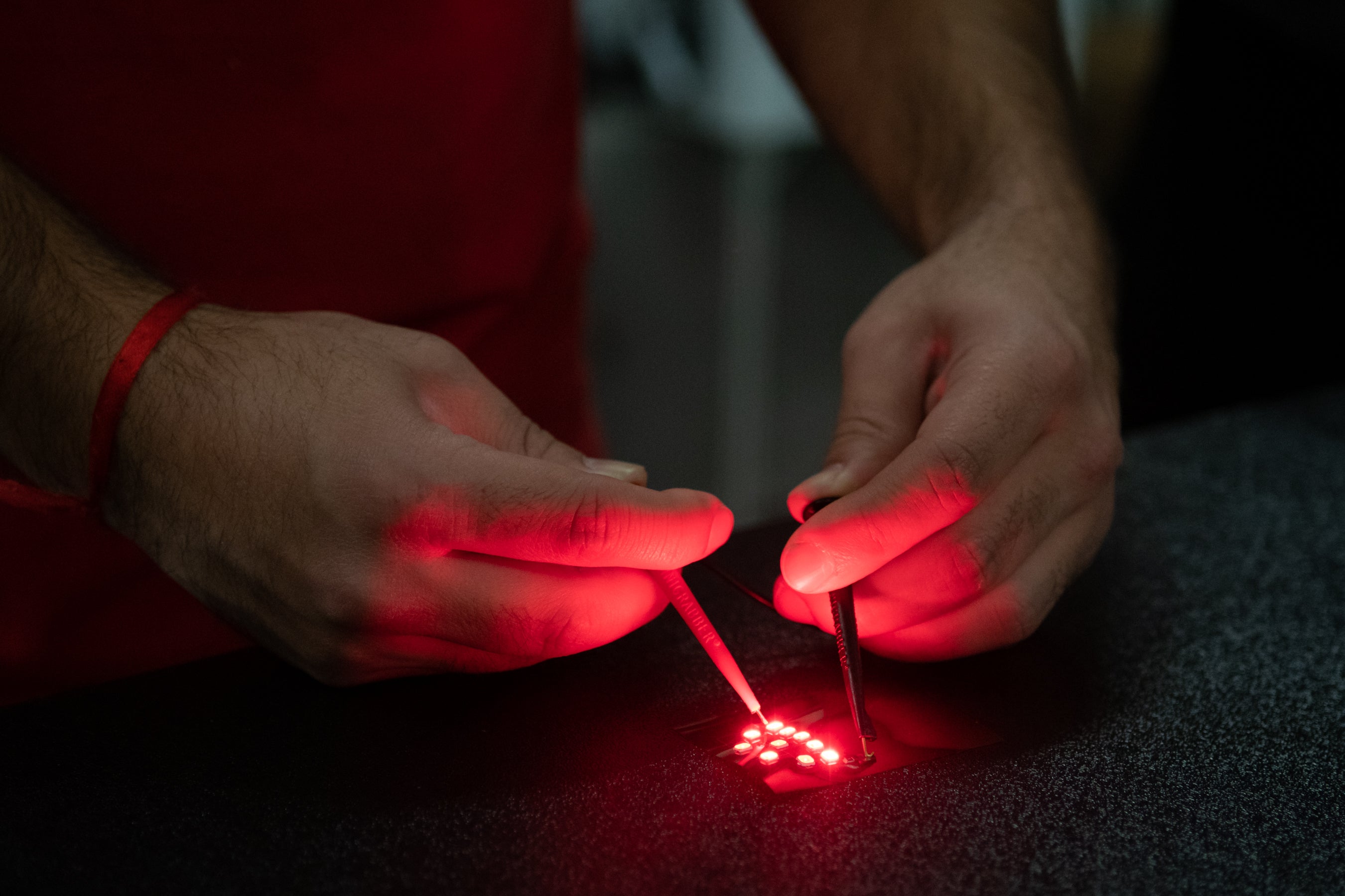 researcher tests LEDs printed with flexible metals
