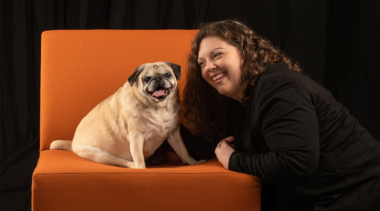 woman and dog pose on orange chair