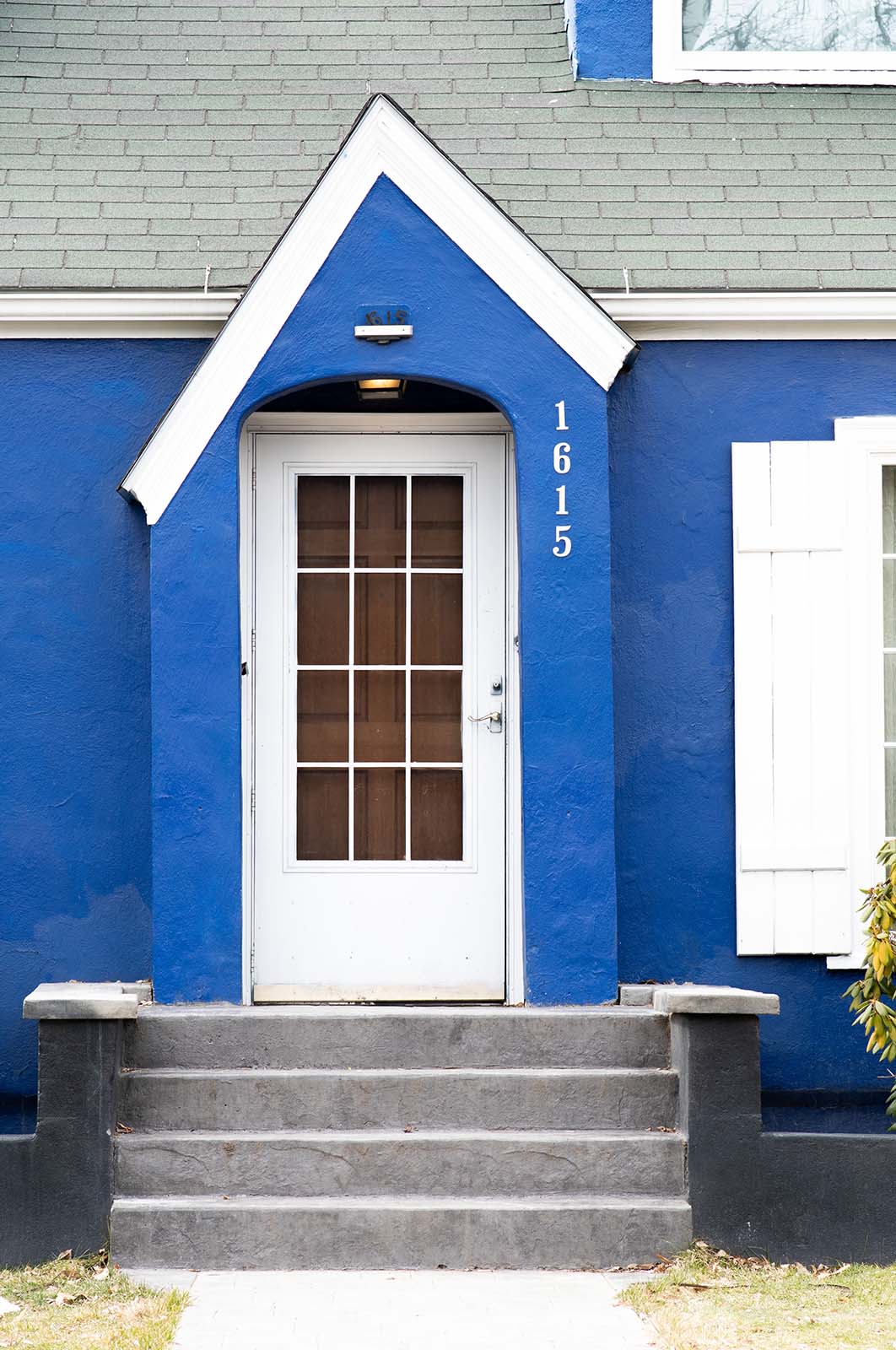 A white door on a blue house