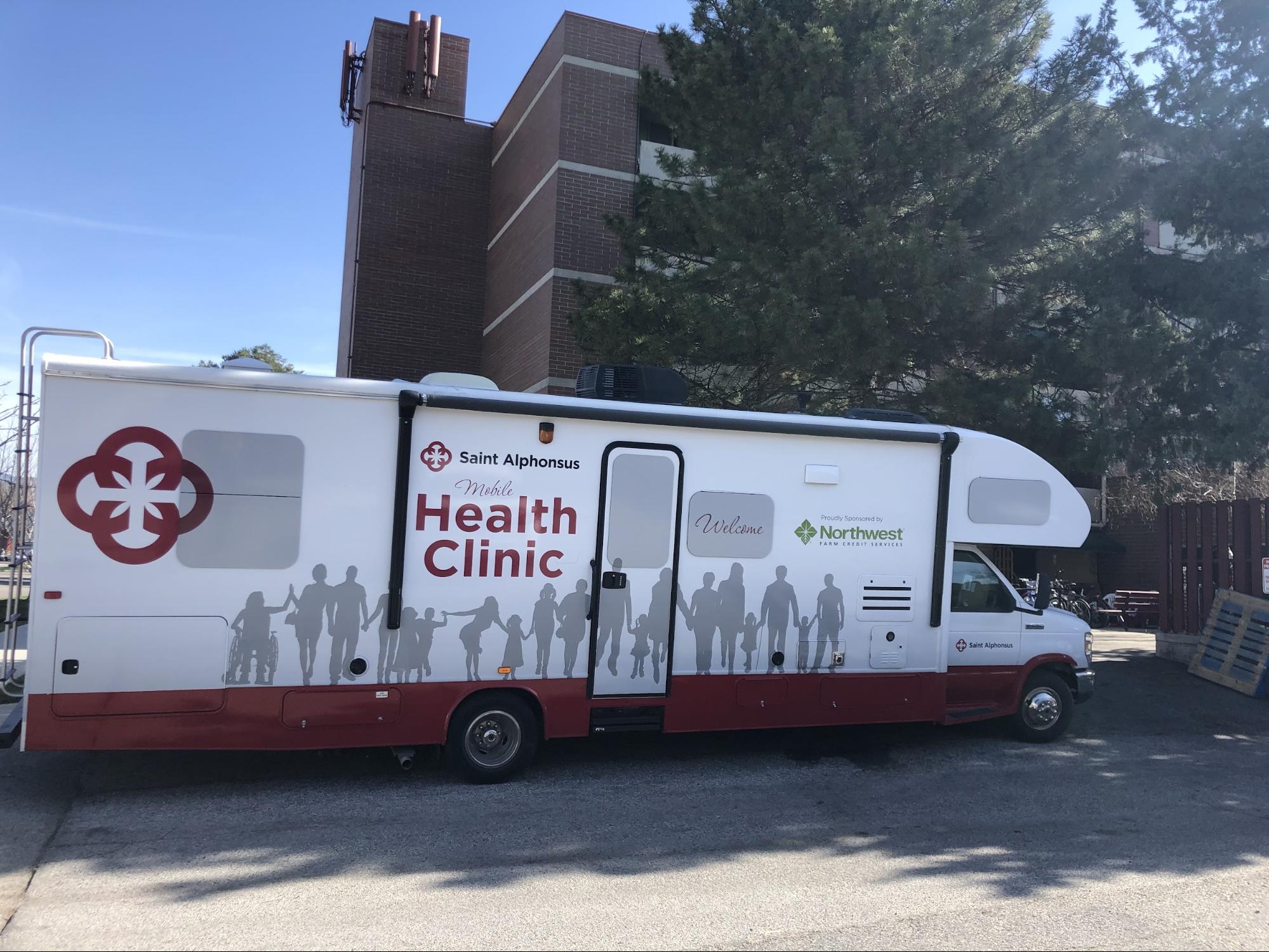 Saint Alphonsus Mobile Health Clinic bus parked.
