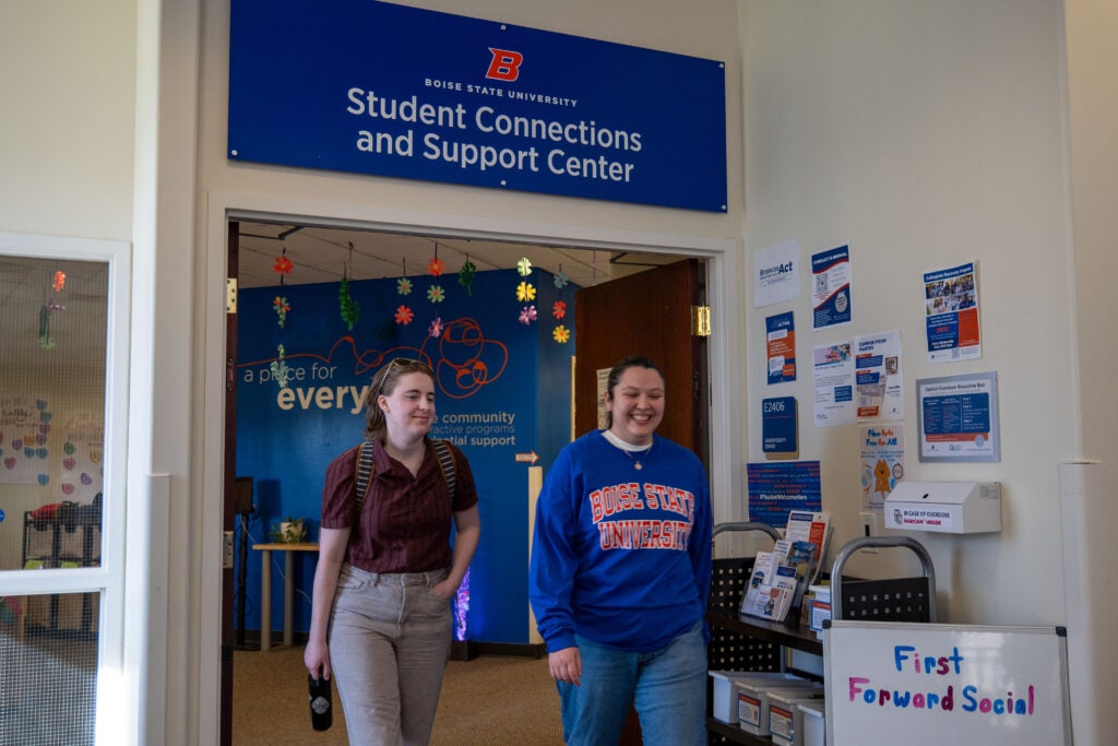 A image of two students walking out the Student Connections and Support Center.