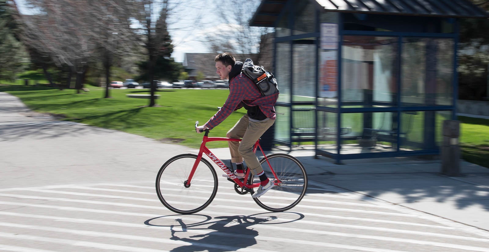 A person bicycling through the Boise State campus
