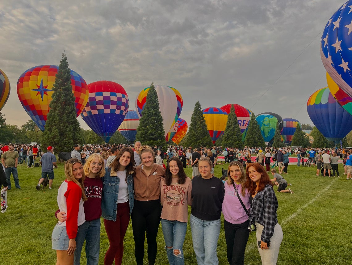 Friends posing for a photo at the Spirit of Boise hot air balloon event