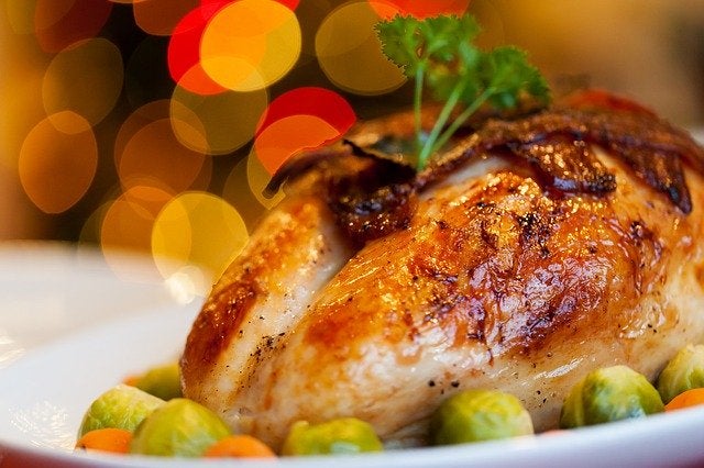 A turkey with brussel sprouts on a platter. 