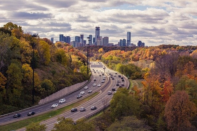 A view of a busy interstate leading into a large city. 