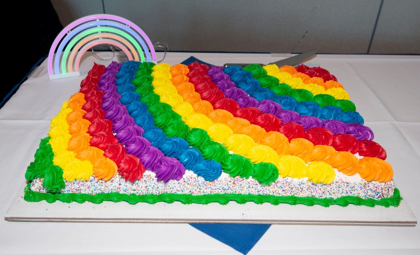 A cake with rainbow colored frosting. 