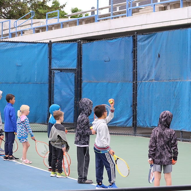 Young campers playing tennis