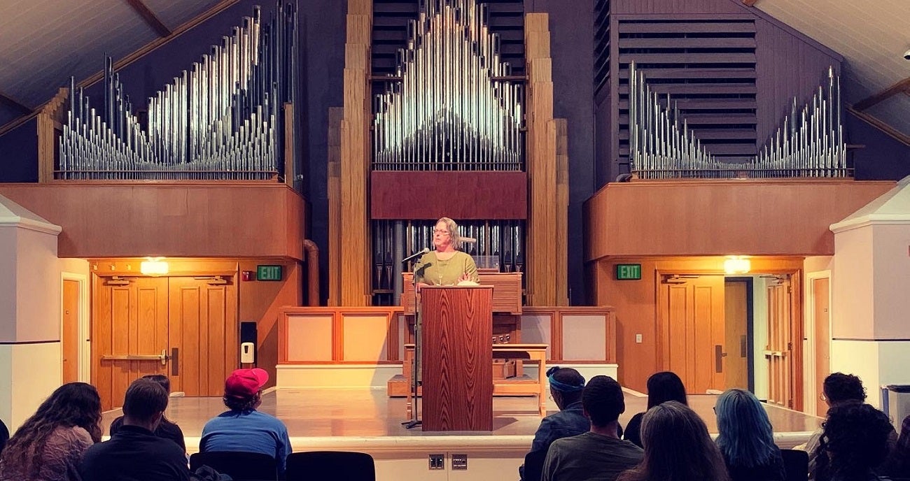 Poet and professor Kerri Webster gives a reading in the Hemingway Center in front of the organ