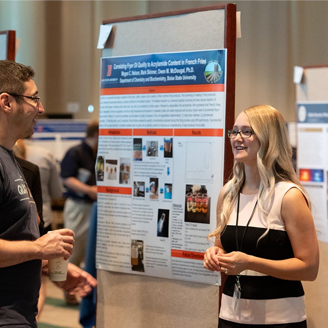 HERC fellow shares her research with a conference attendee