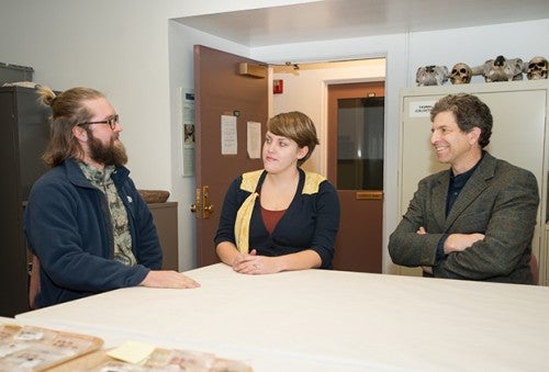 Photo of three people talking at a table