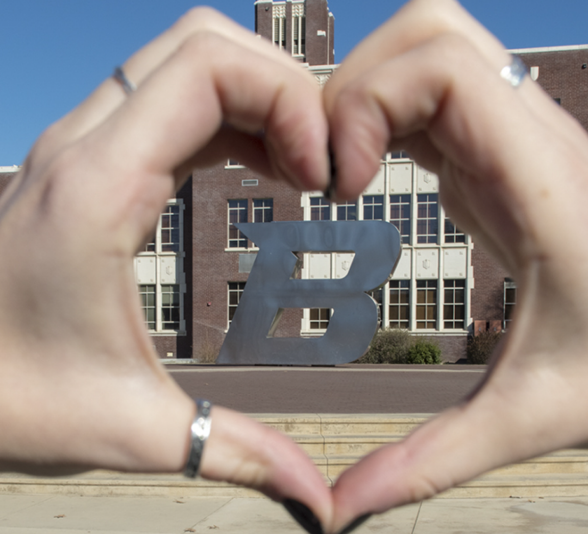 hands making a heart with the Boise State B in the background