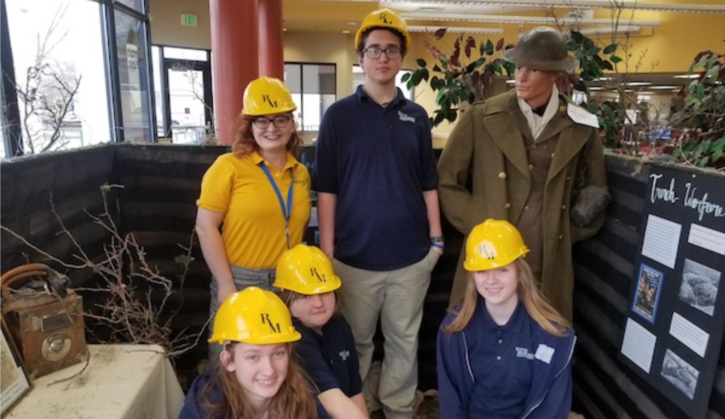 Calista Houdek with students and World War I display.