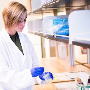 Graduate Research Assistant tests sample in lab