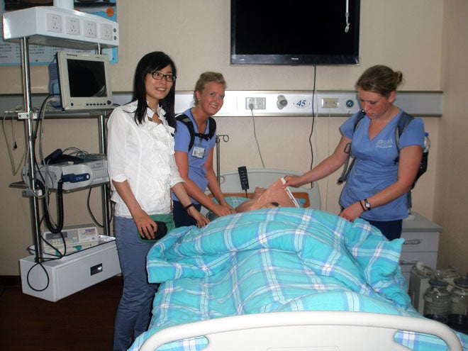 Boise State students explore a Chinese simulation manikin.