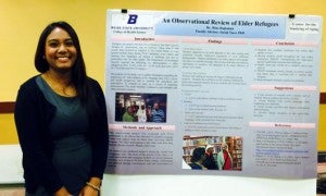 Rina Rajbahak with her poster on refugees at the 2014 Undergraduate Research Conference