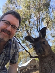 Dave Schmitz and a kangaroo share a selfie.