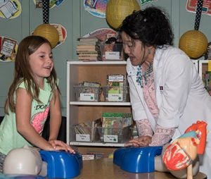 Picture of a Garfield elementary student learning CPR with a School of Nursing faculty.