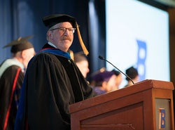 Randy Magen in regalia at podium