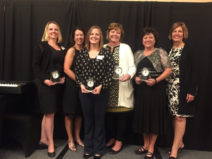 Jody Acheson, Pam Strohfus and Becky Bunderson Stand amond other winners with their awards