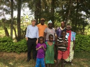 Professor Uwe Reischl with a family in Kenya 