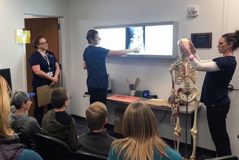 Students showing x-rays to homeschool students