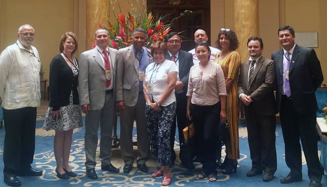 Leslie standing with other members of the conference in Peru 