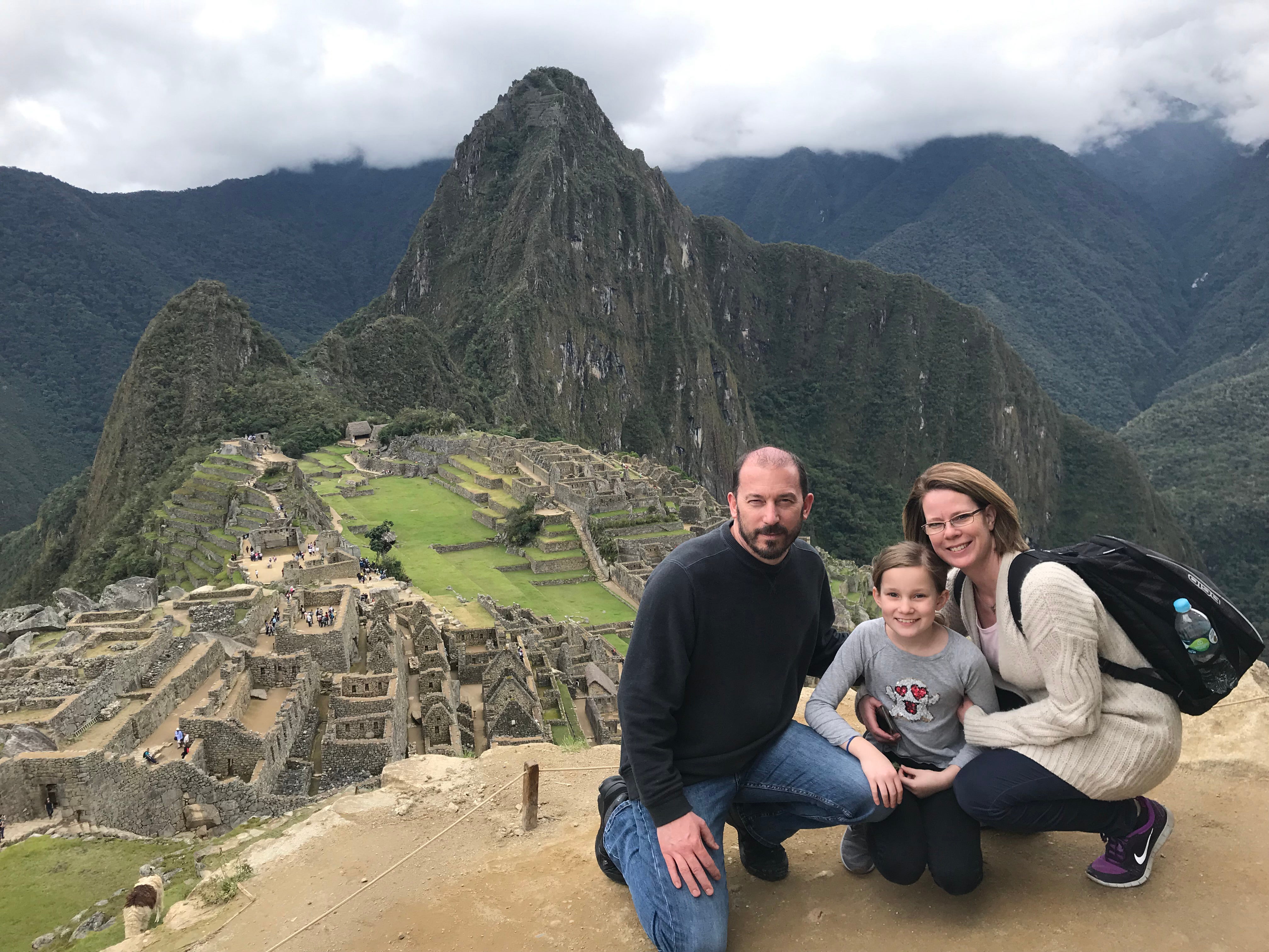 Kendrick and her family sitting at machu picchu 