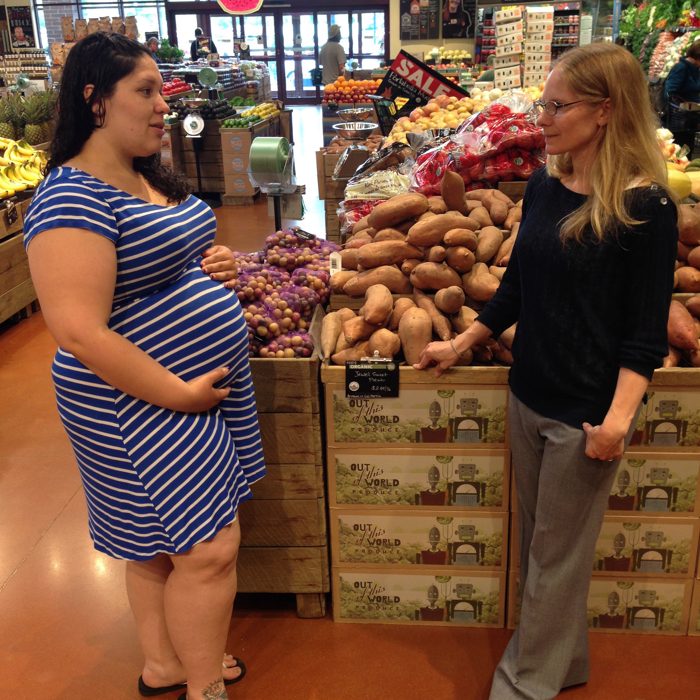 Cynthia Curl (right) discusses her study with Taylor Barrera-Lopez in the produce section of a local grocery store.