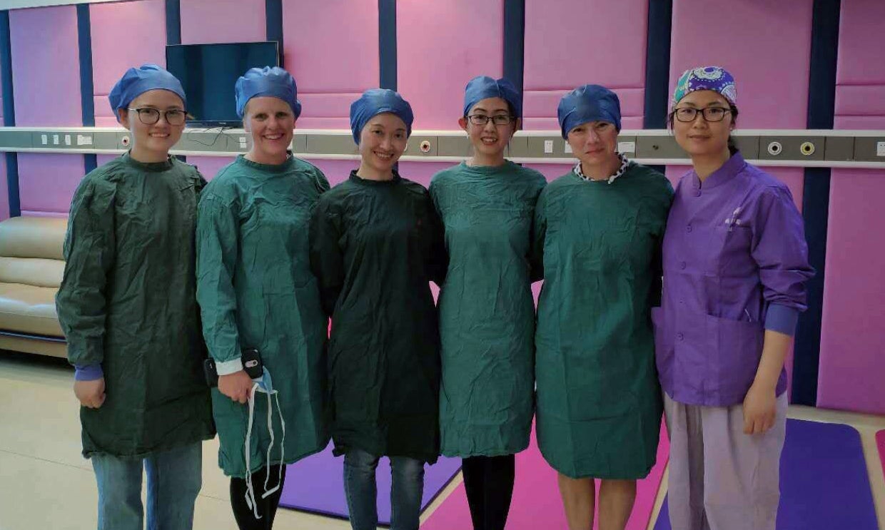 Kelley Connor in a hospital posing with nurses in China