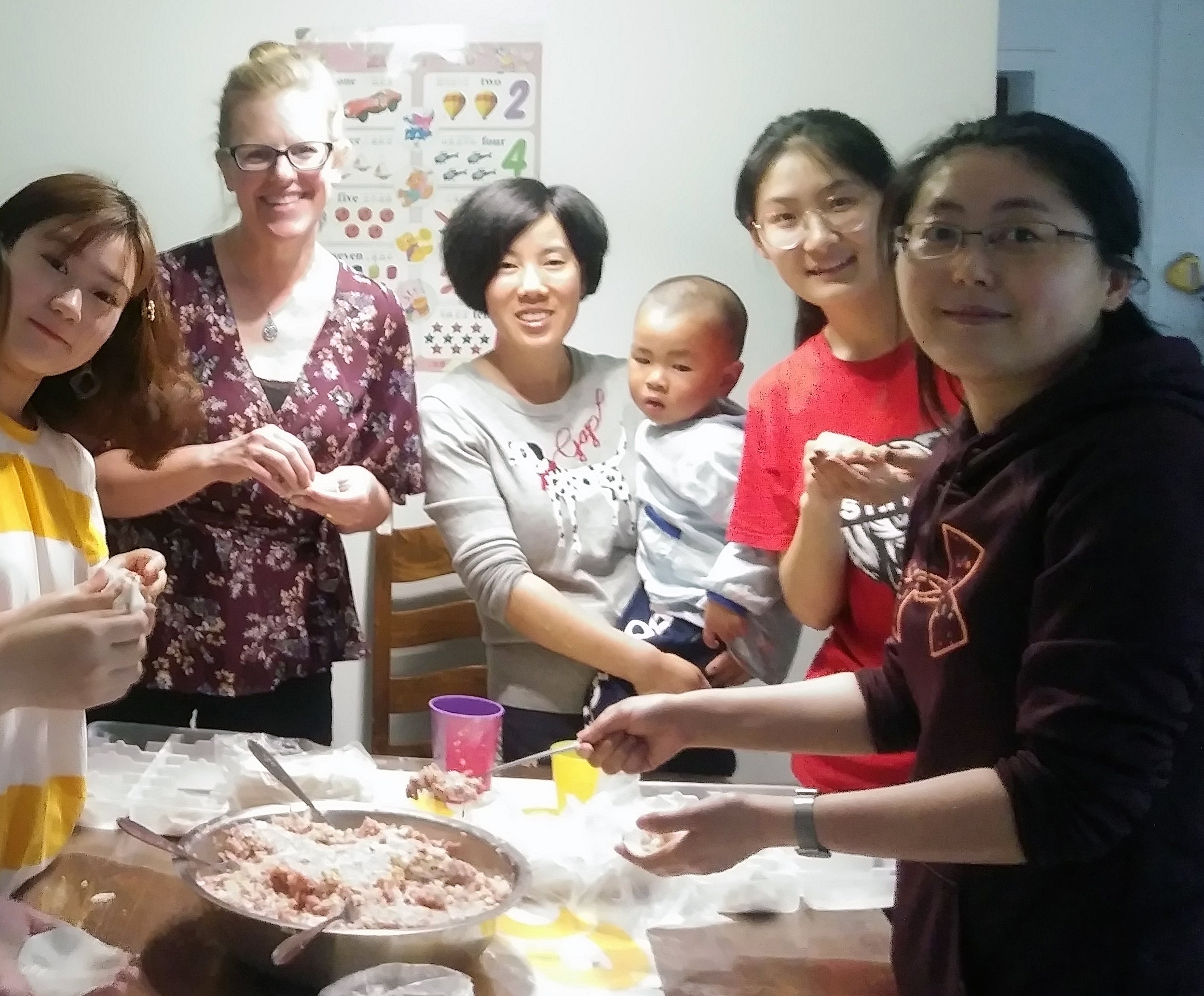 Kelley Connor making dumplings with students and other faculty from China 