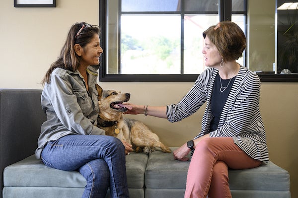 Nicole Lang interacts with WestVet client Joyce Nokes and her dog Merle, Allison Corona photo.