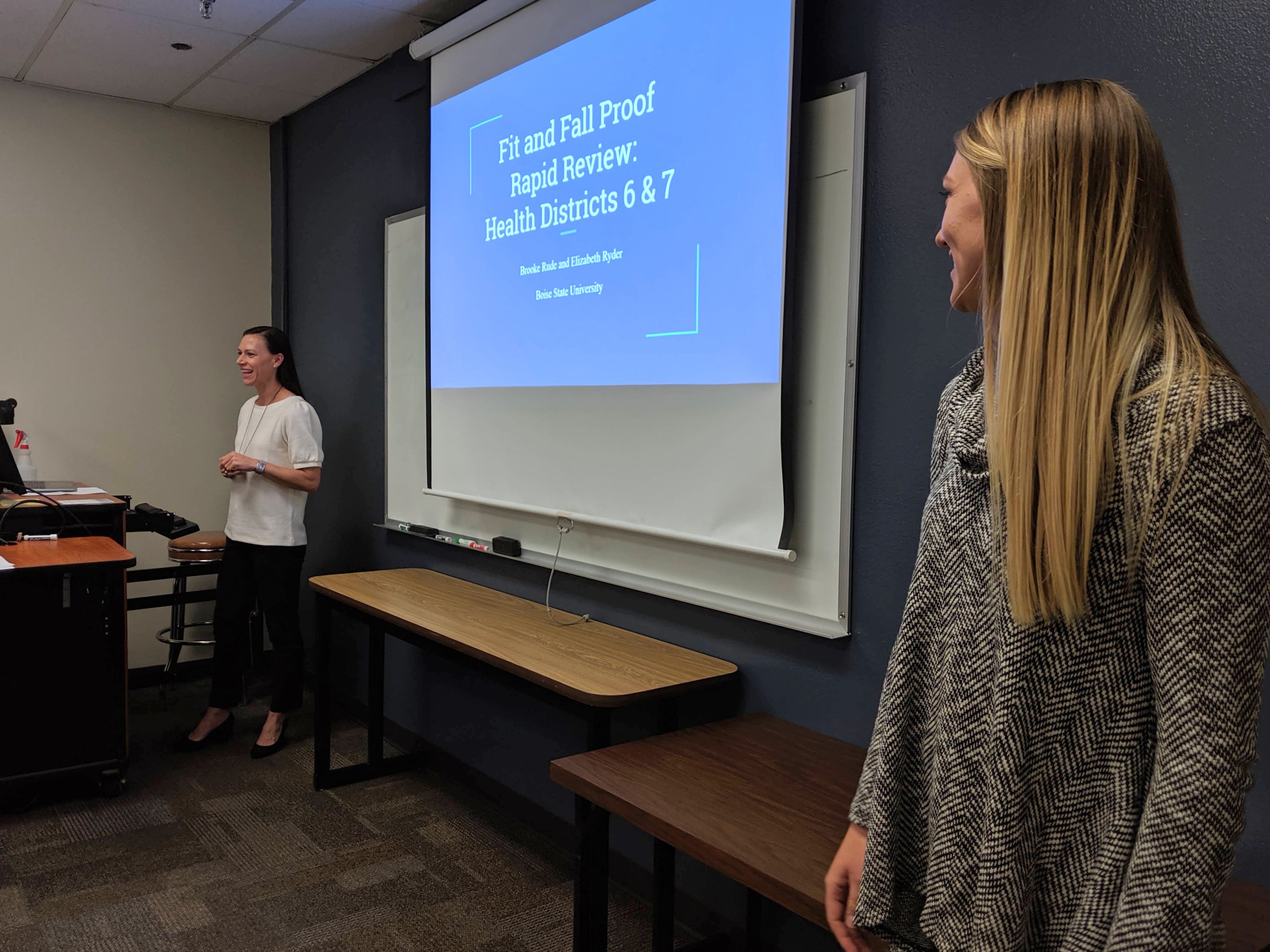 Students Elizabeth Ryder (left) and Brooke Rude (right) present their findings on Health Districts 6 and 7.