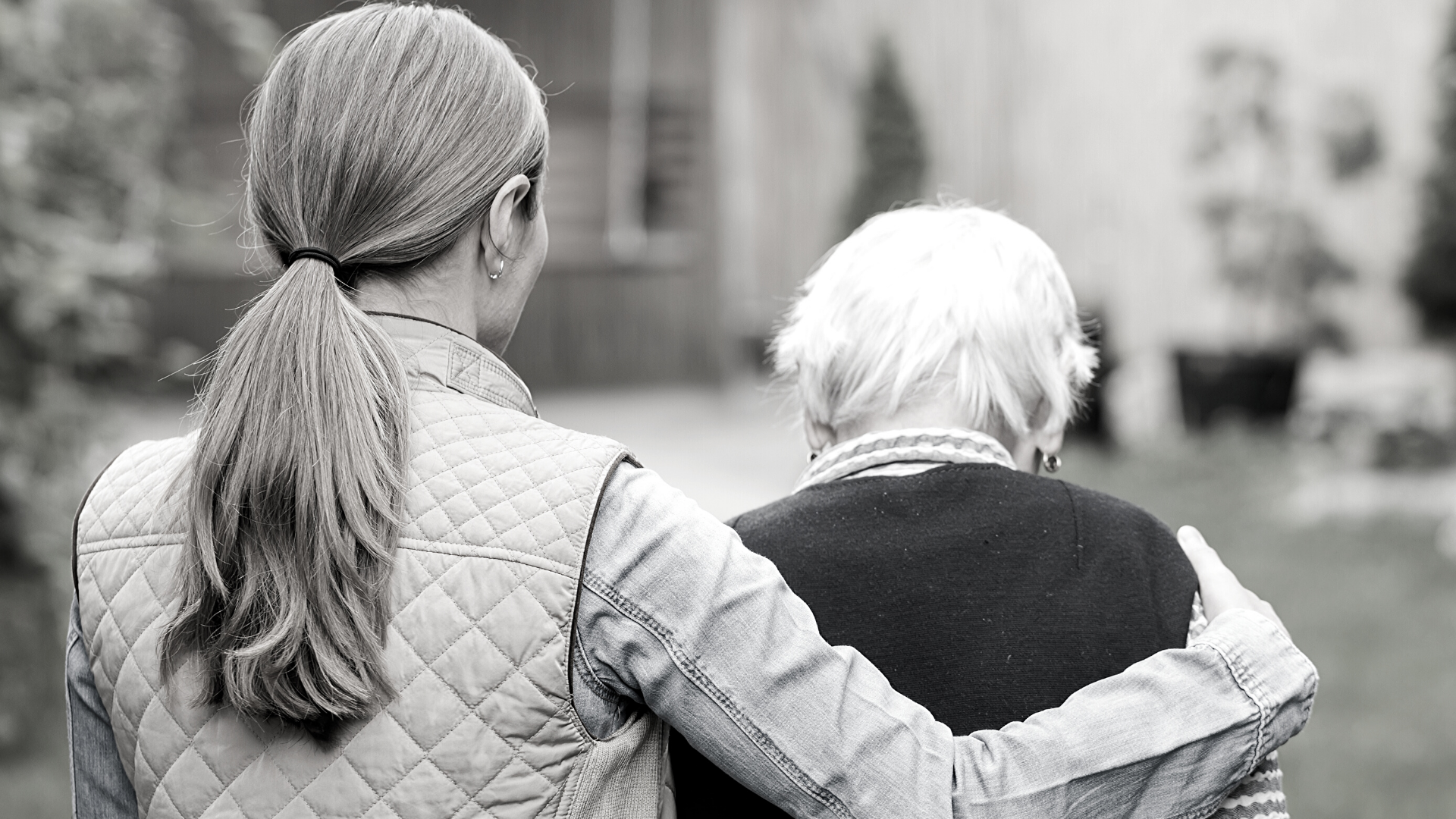 woman helping elderly person 