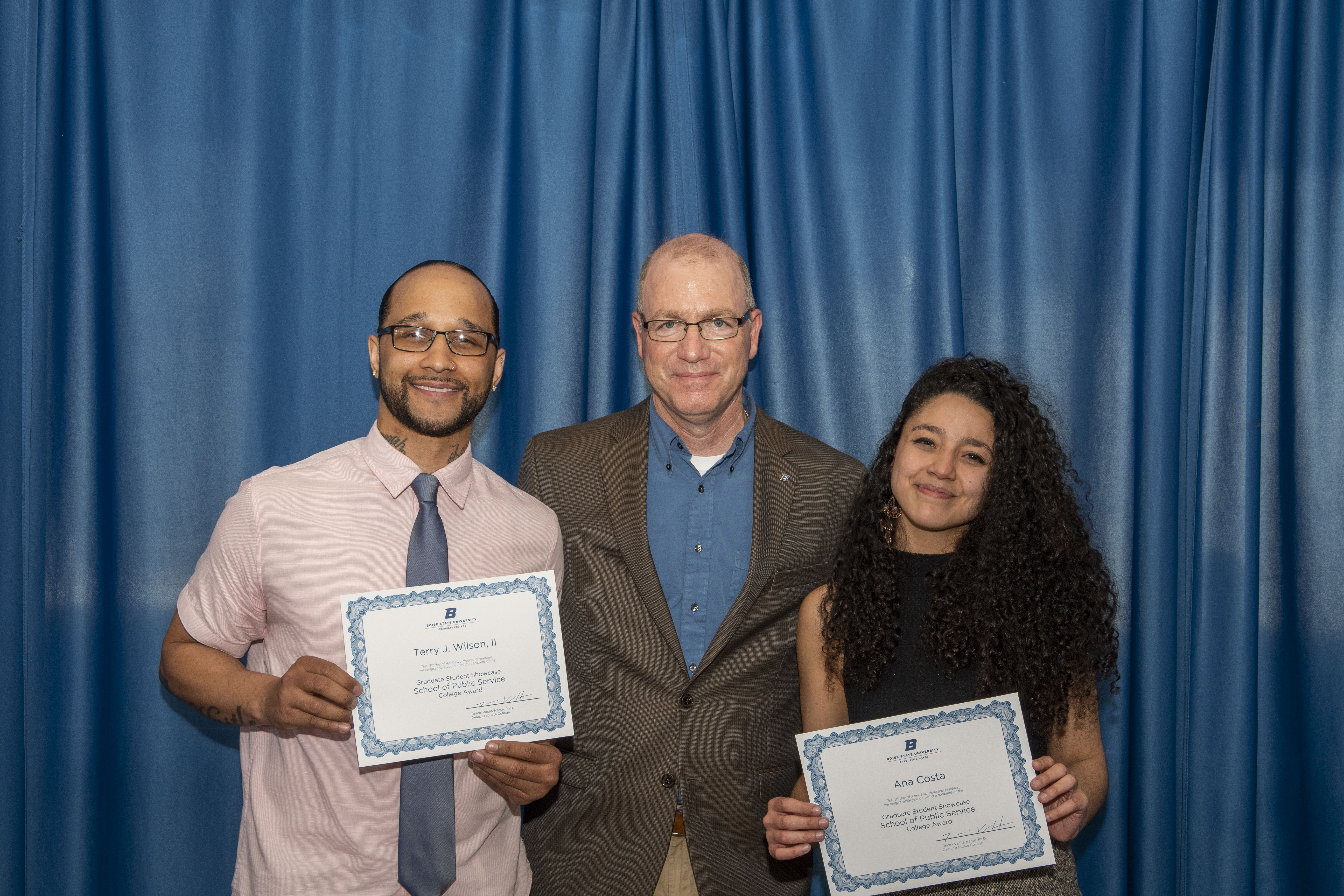 Two of 70 award winners, Terry Wilson II (left), and Ana Costa (right) pose with School of Public Service Associate Dean Andrew Giacomazzi (center)