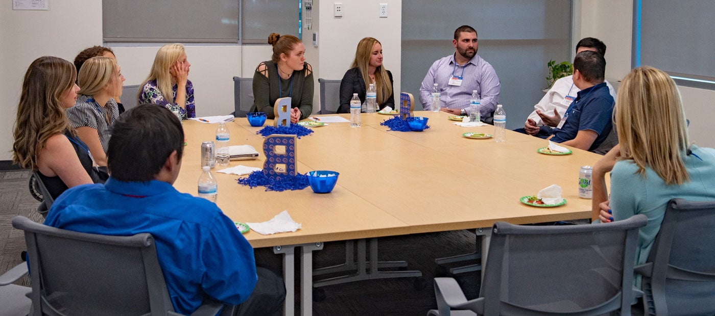 BOLD Graduates taking around a table