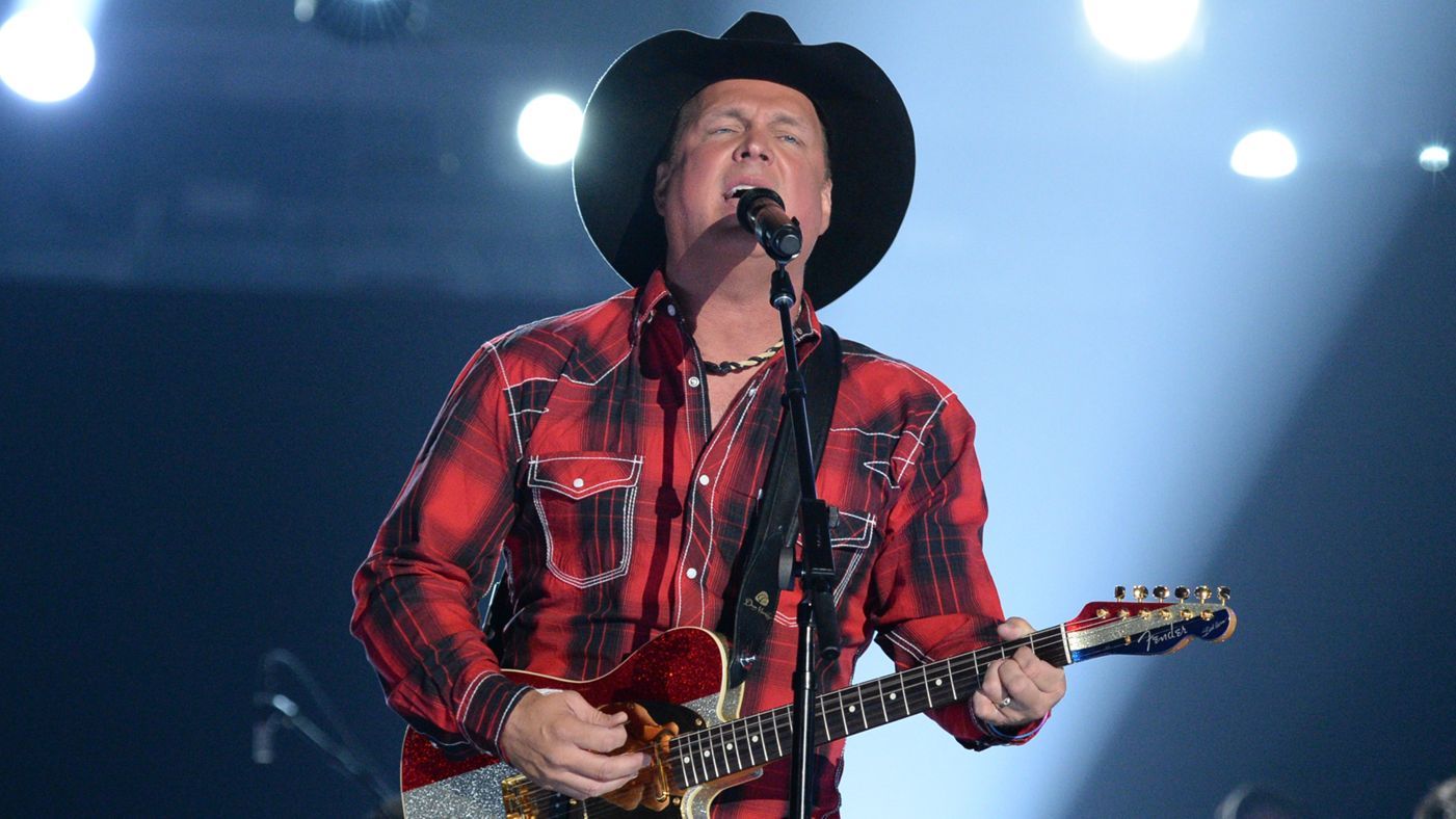 Garth Brooks sings and plays guitar on stage