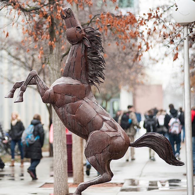 Brown steel statue of a bronco on its hind legs