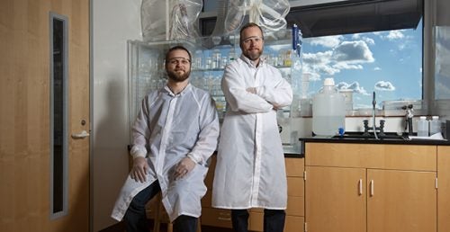 Corey Wall and Mark Schmitz pose for a photo inside the the Isotope Geology Lab