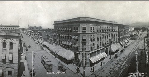 a panned out black and white photo of old downtown boise