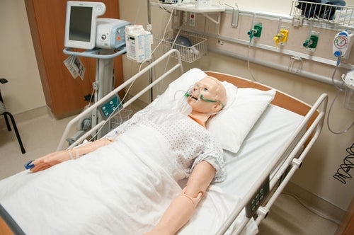 High Fidelity Manikin in hospital bed with oxygen mask on face